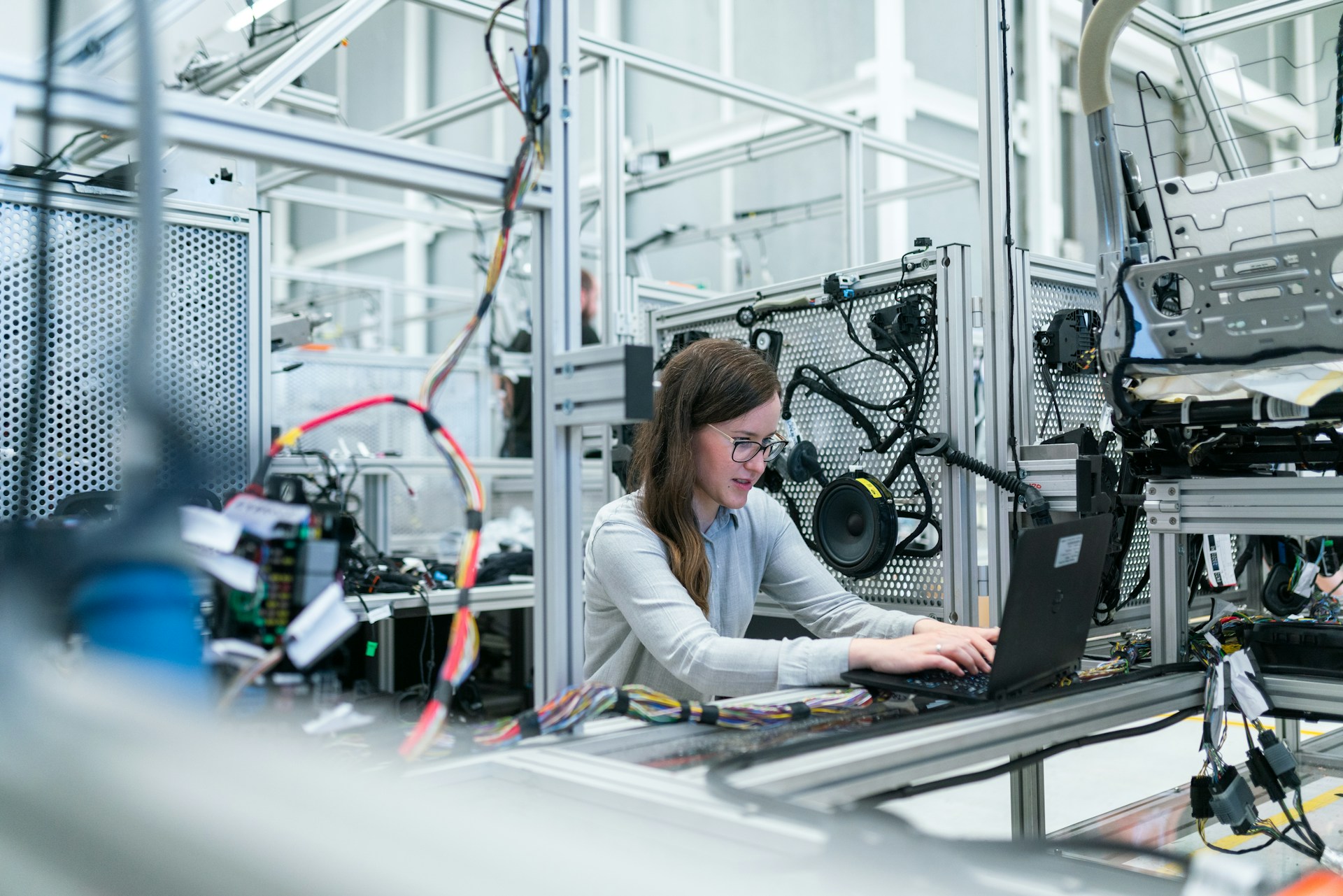 Engineer monitoring mechanical equipment in a workshop